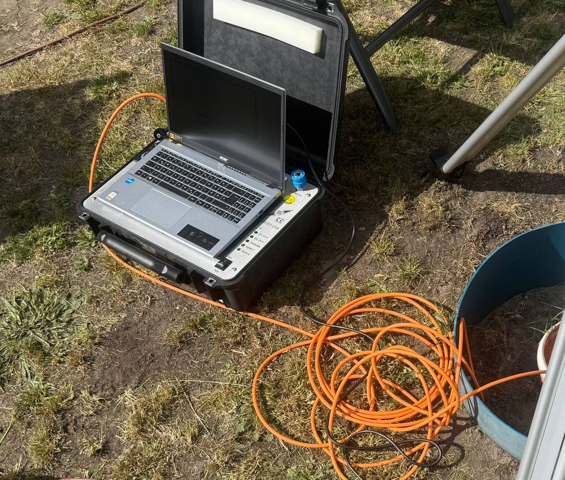 Dichtwehr Prüfequipment – Messlaptop im Feldkoffer und Prüfkabel bei der Dichtheitsprüfung einer Abwassersammelgrube